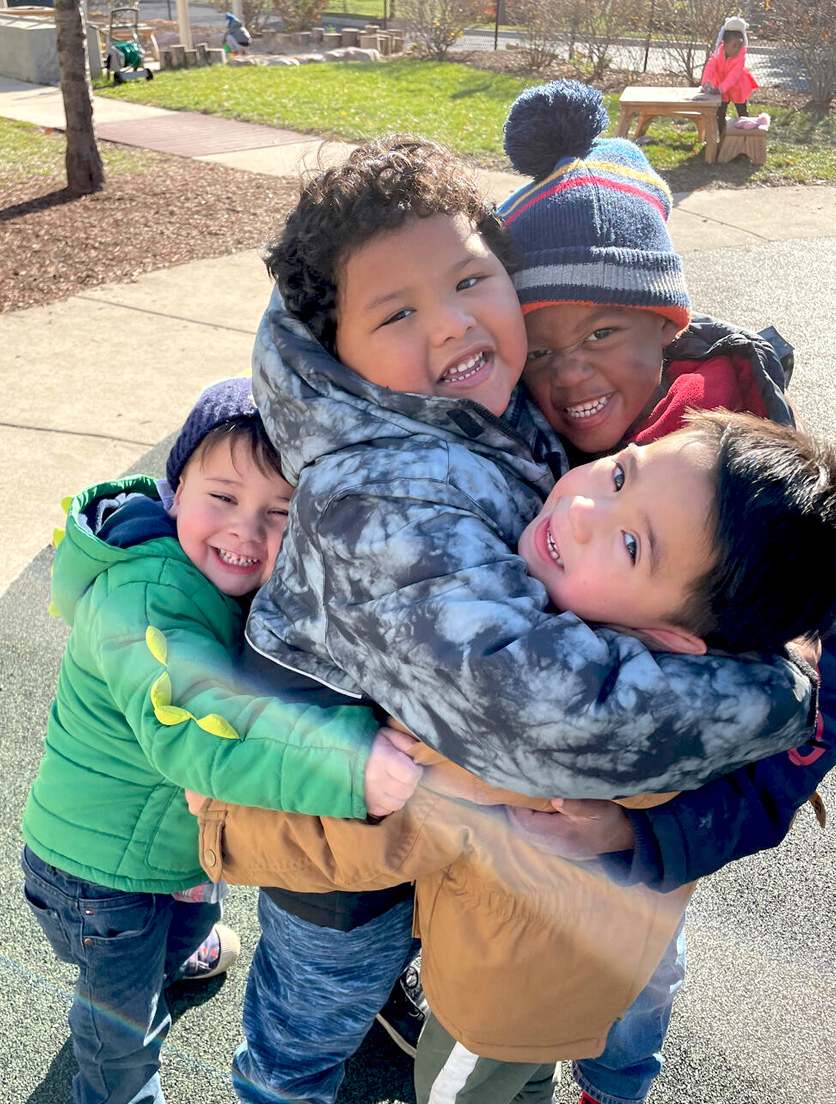 Group of boys hugging outdoors.
